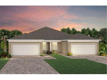 Beautiful single-story home with a two-car garage, lovely lawn, and charming landscaping at 6322 Dew Drop Loop, St Cloud, FL 34771