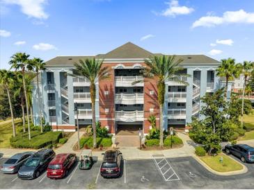 Beautiful condo building with tropical landscaping and ample parking at 7613 Cabana Ct # 402, Reunion, FL 34747