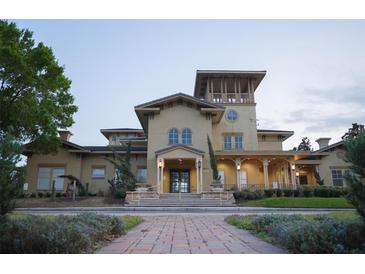 Inviting clubhouse entrance featuring well-manicured landscaping and elegant architectural details at 122 Vista Verdi Cir # 216, Lake Mary, FL 32746