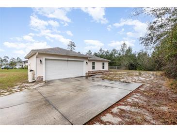 Charming single-story home featuring a two-car garage and an extra wide driveway at 195 Maple Dr, Kissimmee, FL 34759