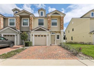 Charming townhome with a brick driveway and stone accents on the facade at 3167 Crown Jewel Ct, Winter Park, FL 32792