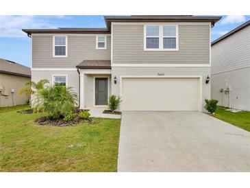 Charming two-story home featuring a two-car garage and well-maintained landscaping in a suburban neighborhood at 5663 Keaton Springs Dr, Lakeland, FL 33811