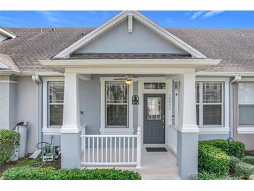 Inviting front porch with white railings and ceiling fan, creating a welcoming entrance at 14472 Chinese Elm Dr, Orlando, FL 32828