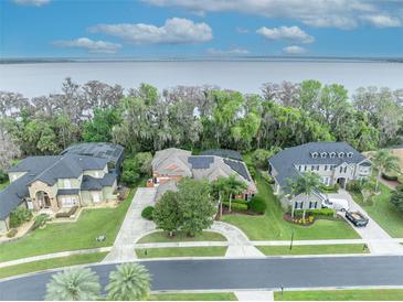 Neighborhood with stunning lake views and serene waterfront homes with lush landscaping and beautiful architecture at 210 Torcaso Ct, Winter Springs, FL 32708