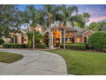 Charming home featuring a circular drive and mature landscaping creating great curb appeal at 210 Torcaso Ct, Winter Springs, FL 32708