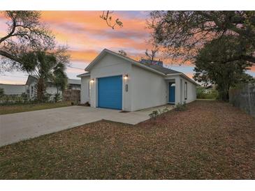 Charming home featuring a blue garage door and a well-maintained front yard at 2206 W Pine St, Orlando, FL 32805