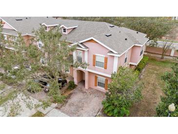 Two-story townhome featuring a blend of classic and modern elements and a private brick driveway at 2336 Caravelle Cir, Kissimmee, FL 34746