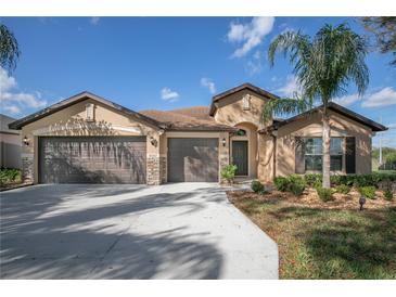 Charming single-story home with a well-manicured lawn, three-car garage, and neutral color palette at 32107 Spring Meadow Ct., Sorrento, FL 32776