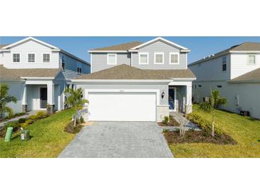 Charming two-story home featuring a two-car garage, well-manicured lawn and nicely landscaped front yard at 3312 Lilac Wa, Davenport, FL 33897