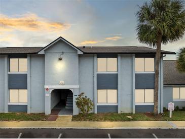 Exterior view of condominium complex featuring modern design, palm trees, and well-maintained landscaping at 4705 S Texas Ave # 4705D, Orlando, FL 32839