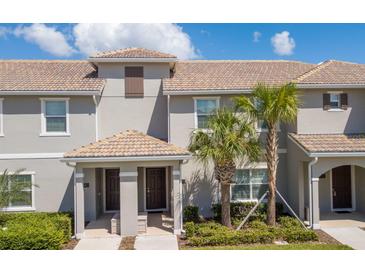 Charming townhome featuring a tile roof, well-maintained landscaping, and covered entryways at 4844 Romeo Cir, Kissimmee, FL 34746