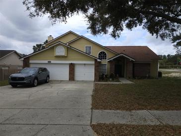 Charming two-story home featuring a two-car garage, well-maintained lawn, and inviting entrance at 6630 Abeydon Ct, Orlando, FL 32818