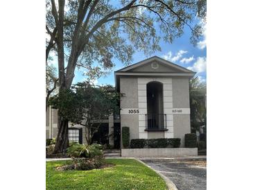 Attractive multi-story condo building with mature trees and manicured landscaping, providing curb appeal at 1055 Kensington Park Dr # 111, Altamonte Springs, FL 32714