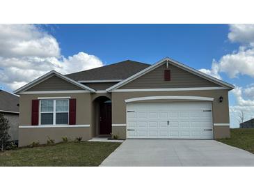 Charming single-story home with neutral paint, white trim, and attached two-car garage at 3178 Partington Blvd, Davenport, FL 33837