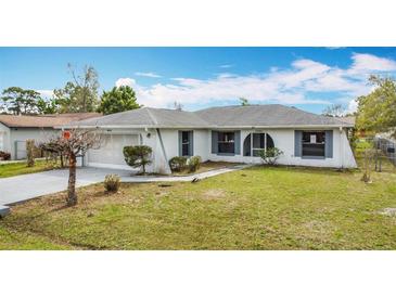 Charming single-story home featuring an attached garage and well-maintained lawn at 606 Heraldo Ct, Kissimmee, FL 34758