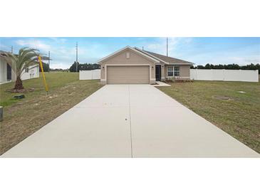 Charming single-story home featuring a spacious driveway and attached two-car garage at 947 Cumberland Dr, Kissimmee, FL 34759