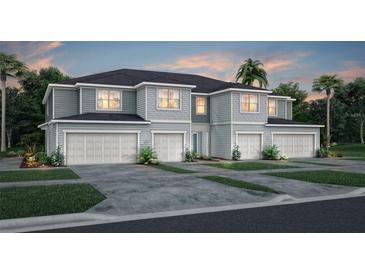 Inviting townhomes with modern curb appeal, featuring attached garages and well manicured landscaping at 3199 Emerald Acres Ln, Sanford, FL 32771