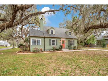 Charming single-Gathering home with a landscaped front yard and a pop of color on the front door at 201 W 16Th St, Sanford, FL 32771