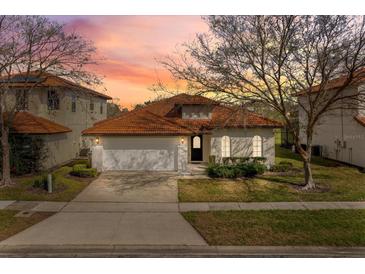 Charming single Gathering home with clay tile roof, well manicured lawn, and two car garage at 304 Summer Place Loop, Clermont, FL 34714