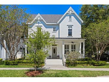 Charming two-story home featuring a inviting front porch and beautifully landscaped yard at 5189 Fenwood Ln, Orlando, FL 32814