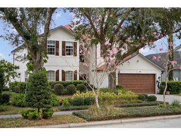 Charming two-story home with lush landscaping and a two-car garage at 5314 Adair Oak Dr, Orlando, FL 32829