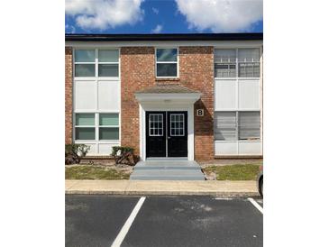 A brick building exterior with double doors and large windows offering natural light at 5325 Curry Ford Rd # B201, Orlando, FL 32812