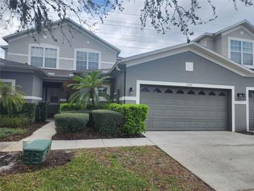 Charming two-story home featuring a well-manicured lawn and a neutral gray color scheme at 1004 Travertine Ter, Sanford, FL 32771