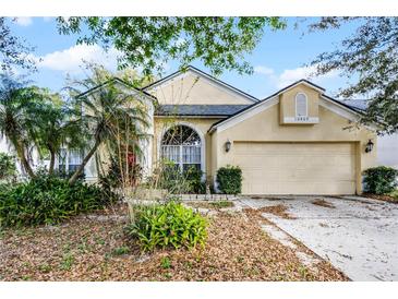 Charming single-story home with a well-manicured lawn and a two-car garage at 10809 Oak Glen Cir, Orlando, FL 32817