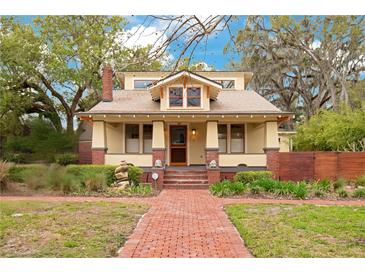 Charming home featuring a brick walkway, well-maintained landscaping, and cozy front porch at 1920 S Palmetto Ave, Sanford, FL 32771