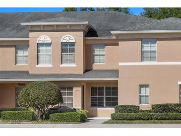 Charming townhome featuring a neutral stucco facade, well-maintained landscaping, and architectural details at 248 Carina Cir, Sanford, FL 32773