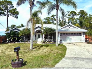 Charming single-story home with well-manicured lawn, mature landscaping and a two-car garage at 2674 Kingsdale Dr, Deltona, FL 32738