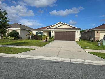 Charming single-story home with a well-maintained lawn and a two-car garage at 3209 Casa Del Rey Ave, Kissimmee, FL 34746