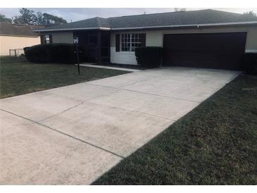 Charming single story home featuring an attached garage and mature landscaping at 759 Swallow St, Deltona, FL 32725