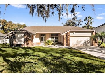 Charming single-story home with a well-manicured lawn and inviting front entrance at 7609 Sandstone Dr, Orlando, FL 32836