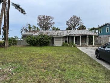 Modest single story home with overgrown landscaping at 1754 Lake St, Oviedo, FL 32765