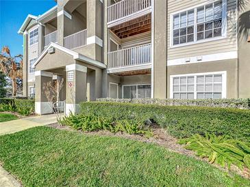 Inviting condo exterior featuring lush landscaping and multiple balconies and entry area at 4280 Summer Landing Dr # 204, Lakeland, FL 33810