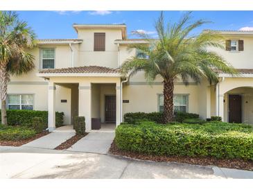 Charming townhome with manicured landscaping and a welcoming covered entrance at 4841 Romeo Cir, Kissimmee, FL 34746