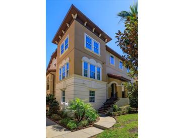 Elegant multi-story home with beautiful architectural details and lush landscaping at 528 Lobelia Dr, Lake Mary, FL 32746
