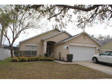 Charming single-story home with a well-maintained lawn, inviting front entrance, and an attached two-car garage at 536 Dunoon St, Ocoee, FL 34761