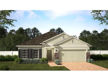 Charming single-story home featuring a two-car garage and a beautifully landscaped front yard, offering inviting curb appeal at 6044 Vision Rd, St Cloud, FL 34771