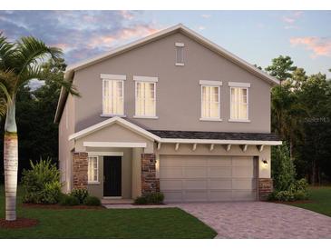 Two-story home showing the front door, two-car garage, a paved driveway, and a palm tree in the front yard at 872 Scrub Oak Hammock Rd, Davenport, FL 33837