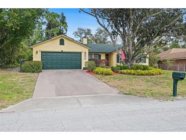 Charming single-Gathering home features a two-car garage, and mature landscaping at 1113 Lyric Dr, Deltona, FL 32738