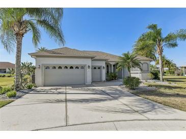 Charming home featuring a three-car garage and mature landscaping under clear blue skies at 12018 Se 175Th Loop, Summerfield, FL 34491