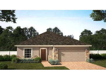 Charming single-Gathering home with stone accents, a two-car garage, and a well-manicured lawn at 14709 Erice Ave, Clermont, FL 34714