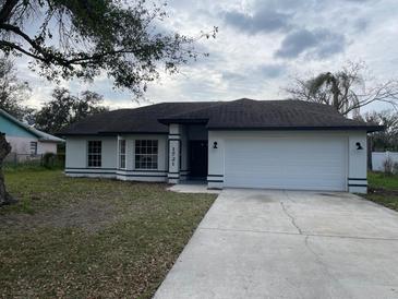 Charming single-story home with a two-car garage and well-maintained lawn at 1721 Sandalwood Sw Cir, Winter Haven, FL 33880