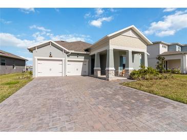 Charming single-Gathering home featuring a 2-car garage and brick paved driveway at 18441 Mowry Ct, Orlando, FL 32827