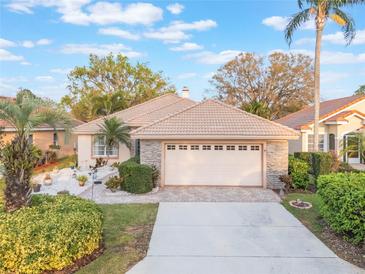 Charming one-story home with a tile roof, two-car garage, and beautifully landscaped front yard at 204 Lake Region S Blvd, Winter Haven, FL 33881