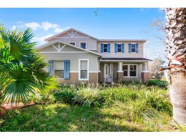 Two story home featuring blue shutters and a landscaped front yard at 2040 Touchwood Ct, Apopka, FL 32712