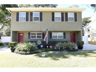 Charming townhome featuring a well-maintained lawn and inviting curb appeal at 210 N East St, Maitland, FL 32751