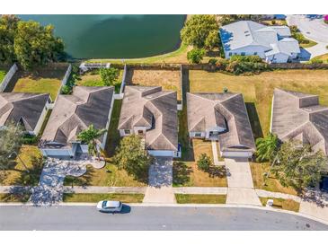 An aerial view shows the home's location on a well maintained street with a pond view at 3722 Madbury Cir, Lakeland, FL 33810